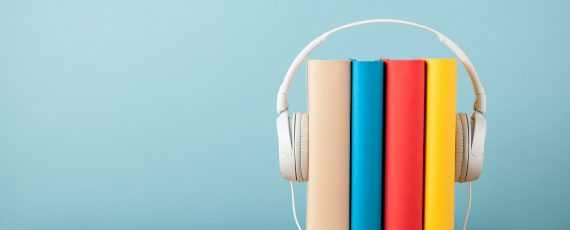 Stack of books with headphones